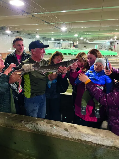 Cultural Integration Program participants, including a family with a baby, on an educational field trip.