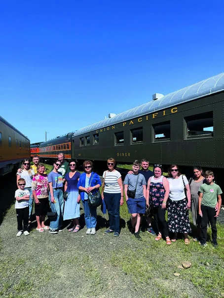 Cultural Integration Program participants beside a vintage Union Pacific train car on a historical field trip.